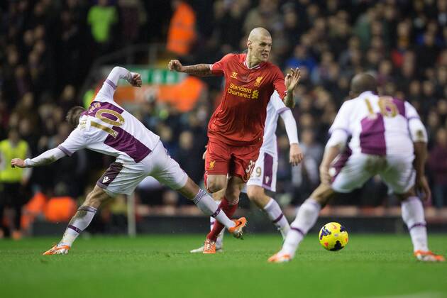 Martin Skrtel of Liverpool skips past an outstretched leg of Andreas Weimann of Aston Villa - Liverpool FC vs. Aston Villa - Barclays Premier League - Anfield - Liverpool - 18 01 2014 Pic PhilipxOldham Sportimage EDITORIAL USE ONLY. No use with unauthorised audio, video, data, fixture lists, club league logos or live services. Online in-match use limited to 120 images, no video emulation. No use in betting, games or single club league player publications.
