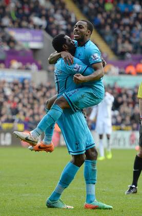 Emmanuel Adebayor of Tottenham celebrates the third goal with Danny Rose of Tottenham - Barclays Premier League - Swansea City vs Tottenham Hotspur - Liberty Stadium - Swansea - Wales - 19th January 2014 - EDITORIAL USE ONLY. No use with unauthorised audio, video, data, fixture lists, club league logos or live services. Online in-match use limited to 120 images, no video emulation. No use in betting, games or single club league player publications.