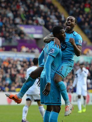 Emmanuel Adebayor of Tottenham celebrates the third goal with Danny Rose of Tottenham - Barclays Premier League - Swansea City vs Tottenham Hotspur - Liberty Stadium - Swansea - Wales - 19th January 2014 - EDITORIAL USE ONLY. No use with unauthorised audio, video, data, fixture lists, club league logos or live services. Online in-match use limited to 120 images, no video emulation. No use in betting, games or single club league player publications.
