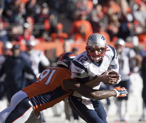 The New England Patriots Tom Brady Sacked by Robert Ayers in the second quarter in the AFC Championship game at Sports Authority Field at Mile High in Denver on January 19, 2014. The New England-Denver winner will play in Super Bowl XLVIII at MetLife Stadium in East Rutherford, New Jersey February 2nd.  DEN2014011913