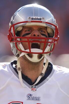 New England Patriots Tom Brady yells at the Denver Broncos fans as he trots to the north end zone for warm up in the AFC Championship game at Sports Authority Field at Mile High in Denver on January 19, 2014. Brady s team lost to the Broncos 26-16 losing the chance to advance to the Super Bowl XLVIII at MetLife Stadium in East Rutherford, New Jersey February 2nd.  DEN201401190435
