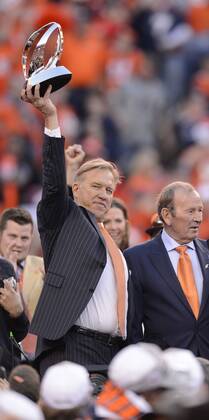 Jan. 18, 2014 - Denver, CO, USA - Broncos executive vice president of football operations John Elway hoists the AFC Championship Trophy at Sports Authority Field at Mile High in Denver on Sunday, Jan. 19, 2014. The Denver Broncos defeated the New England Patriots, 26-16. BRONCOS PATRIOTS - ZUMAm67