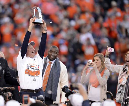 Jan. 18, 2014 - Denver, CO, USA - Broncos head coach John Fox hoists the AFC Championship Trophy at Sports Authority Field at Mile High in Denver on Sunday, Jan. 19, 2014. The Denver Broncos defeated the New England Patriots, 26-16. BRONCOS PATRIOTS - ZUMAm67