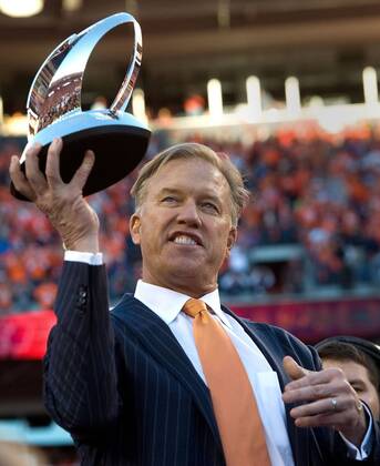 Jan. 18, 2014 - Denver, CO, USA - Broncos executive vice president for football operations John Elway holds the AFC Championship trophy at Sports Authority Field at Mile High in Denver on Sunday, Jan. 19, 2014. The Denver Broncos defeated the New England Patriots, 26-16. BRONCOS PATRIOTS - ZUMAm67