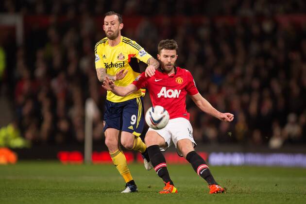 Steven Fletcher of Sunderland and Michael Carrick of Manchester United battle - Manchester United vs. Sunderland - Capital One Cup Semi Final Second Leg - Old Trafford - Manchester - 22 01 2014 Pic Philip Oldham Sportimage EDITORIAL USE ONLY. No use with unauthorised audio, video, data, fixture lists, club league logos or live services. Online in-match use limited to 120 images, no video emulation. No use in betting, games or single club league player publications.