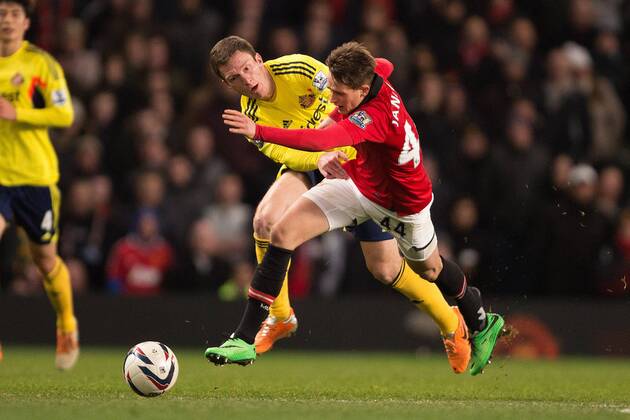Adnan Januzaj of Manchester United (ManU) loses his boot in a battle with Craig Gardner of Sunderland FC - Manchester United (ManU) vs. Sunderland FC - Capital One Cup Semi Final Second Leg - Old Trafford - Manchester - 22 01 2014 Pic Philip Oldham Sportimage EDITORIAL USE ONLY. No use with unauthorised audio, video, data, fixture lists, club league logos or live services. Online in-match use limited to 120 images, no video emulation. No use in betting, games or single club league player publications.