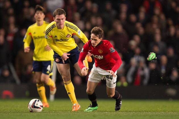 Adnan Januzaj of Manchester United (ManU) loses his boot in a battle with Craig Gardner of Sunderland FC - Manchester United (ManU) vs. Sunderland FC - Capital One Cup Semi Final Second Leg - Old Trafford - Manchester - 22 01 2014 Pic Philip Oldham Sportimage EDITORIAL USE ONLY. No use with unauthorised audio, video, data, fixture lists, club league logos or live services. Online in-match use limited to 120 images, no video emulation. No use in betting, games or single club league player publications.