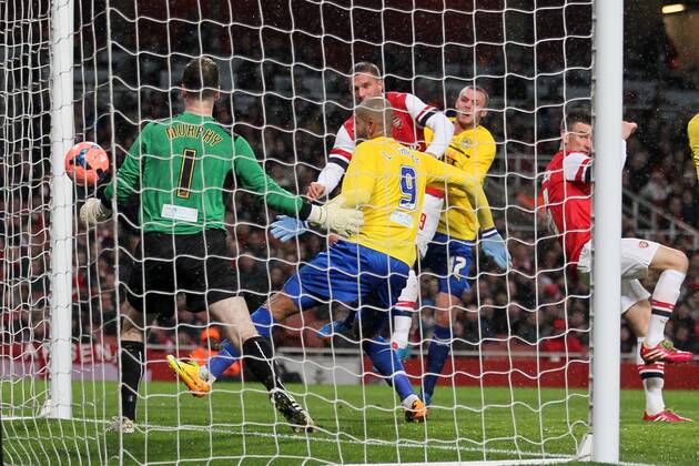 Arsenal s Lukas Podolski scoring his sides second goal - Arsenal FC vs Coventry City - FA Cup Fourth Round - Emirates Stadium - London - England - 24 01 2014 - EDITORIAL USE ONLY. No use with unauthorised audio, video, data, fixture lists, club league logos or live services. Online in-match use limited to 120 images, no video emulation. No use in betting, games or single club league player publications.
