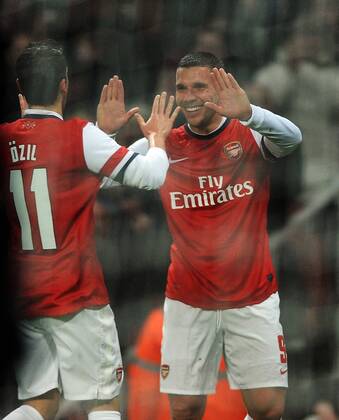 Football - 2013 2014 FA Cup - Fourth Round: Arsenal vs. Coventry City Arsenal s Lukas Podolski celebrates scoring goal no 1 with Mesut Özil at The Emirates. COLORSPORT ANDREW COWIE