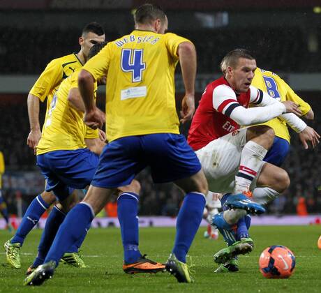 LONDON, Jan. 24, 2014 (Xinhua) -- Lukas Podolski(1st,R) of Arsenal vies with players of Coventry City during FA Cup Fourth Round match between Arsenal and Coventry City at Emirates Stadium in London, Britain on Jan. 24, 2014. 