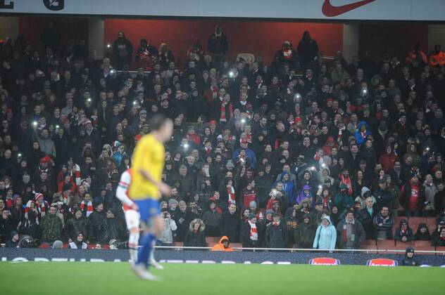 Football - 2013 2014 FA Cup - Fourth Round: Arsenal vs. Coventry City Arsenal s fans use their lighters as the lights fail just before half time at The Emirates. COLORSPORT ANDREW COWIE