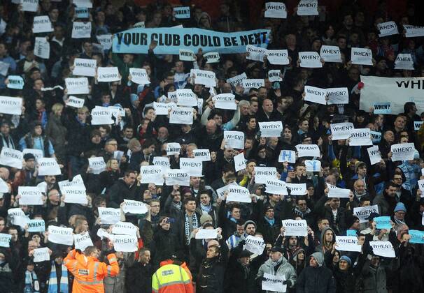 Football - 2013 2014 FA Cup - Fourth Round: Arsenal vs. Coventry City Coventry fans hold up their Protest cards at The Emirates. COLORSPORT ANDREW COWIE