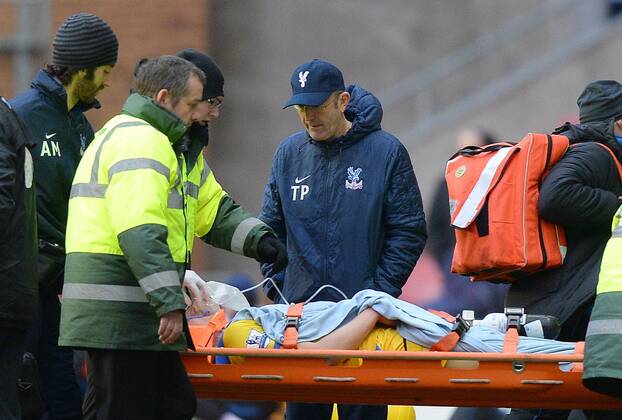 Tony Pullis manager of Crystal Palace checks on Jonathan Parr of Crystal Palace as he is stretchered off - FA Cup 4th round - Wigan Athletic vs Crystal Palace - DW Stadium - Wigan - England - 25th January 2014 - EDITORIAL USE ONLY. No use with unauthorised audio, video, data, fixture lists, club league logos or live services. Online in-match use limited to 120 images, no video emulation. No use in betting, games or single club league player publications.