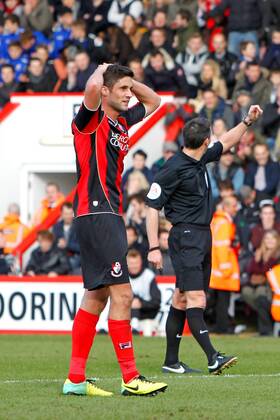 Football - 2013 2014 FA Cup - Fourth Round: AFC Bournemouth vs. Liverpool FC Bournemouth s Andrew Surman (on loan from Norwich City) holds his head after his goalbound shot was deflected over the bar off Kolo Toure of Liverpool Colorsport ShaunxBoggust
