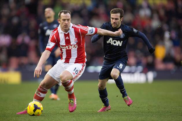 Juan Mata of Manchester United (ManU) hassles Stoke s Charlie Adam - Stoke City vs. Manchester United (ManU) - Premier League - Britannia Stadium - Stoke - 01 02 2014 Pic PhilipxOldham Sportimage EDITORIAL USE ONLY. No use with unauthorised audio, video, data, fixture lists, club league logos or live services. Online in-match use limited to 120 images, no video emulation. No use in betting, games or single club league player publications.