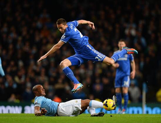 Vincent Kompany of Manchester City catches Nemanja Matic of Chelsea on the shin as he tackles him - Barclays Premier League - Manchester City vs Chelsea FC - Etihad Stadium - Manchester - England - 03rd February 2014 - EDITORIAL USE ONLY. No use with unauthorised audio, video, data, fixture lists, club league logos or live services. Online in-match use limited to 120 images, no video emulation. No use in betting, games or single club league player publications.