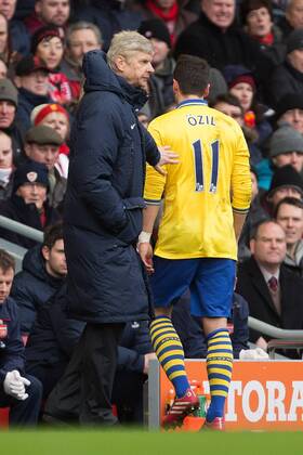 Arsenal s manager, Arsene Wenger pats Mesut Ozil on the back following his substitution - Liverpool vs. Arsenal - Barclays Premier League - Anfield - Liverpool - 08 02 2014 Pic Philip Oldham Sportimage EDITORIAL USE ONLY. No use with unauthorised audio, video, data, fixture lists, club league logos or live services. Online in-match use limited to 120 images, no video emulation. No use in betting, games or single club league player publications.