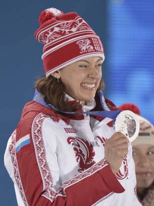 Russia s Olga Vilukhina holds her silver medal during the victory ceremony for the Biathalon Women s Sprint at the Sochi 2014 Winter Olympics on February 10, 2014 in Sochi, Russia.  OLY20140210131