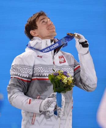 Poland s Kamil Stoch holds his gold medal during the victory ceremony for men s individual normal hill ski jumping at the Sochi 2014 Winter Olympics on February 10, 2014 in Sochi, Russia.  OLY20140210137