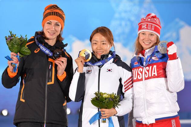 From left to right, bronze medalist, Netherland s Margot Boer, Gold medalist, South Korea s Sang Hwa Lee, and silver medalist, Russia s Olga Fatkulina poses with their medals during the victory ceremony for the ladies speed skating 500m at the Sochi 2014 Winter Olympics on February 12, 2014 in Sochi, Russia.  OLY20140212343