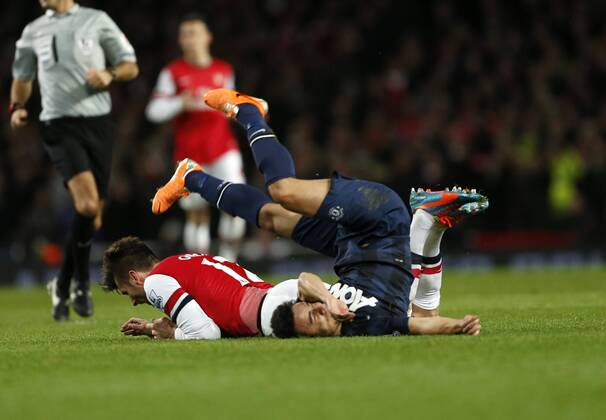 Arsenal s Olivier Giroud clashes with Manchester United s Rafael who lands badly Arsenal London s vs Manchester United (ManU) - Premier League - Emirates Stadium - London - England - 12 02 2014 - Pic DavidKlein Sportimage EDITORIAL USE ONLY. No use with unauthorised audio, video, data, fixture lists, club league logos or live services. Online in-match use limited to 120 images, no video emulation. No use in betting, games or single club league player publications.
