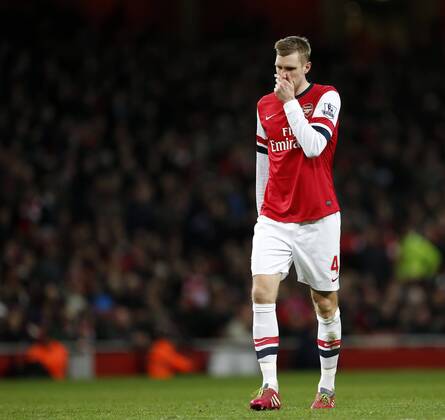 Arsenal s Per Mertesacker looks on dejected Arsenal s vs Manchester United - Premier League - Emirates Stadium - London - England - 12 02 2014 - Pic David Klein Sportimage EDITORIAL USE ONLY. No use with unauthorised audio, video, data, fixture lists, club league logos or live services. Online in-match use limited to 120 images, no video emulation. No use in betting, games or single club league player publications.