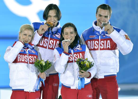 Left to right, Russia s Ksenia Stolbova and Fedor Klimov, Russia s Tatiana Volosozhar and Maxim Trankov pose with their gold and bronze medals during the victory ceremony for figure skating pairs at the Sochi 2014 Winter Olympics on February 13, 2014 in Sochi, Russia.  OLY20140213461