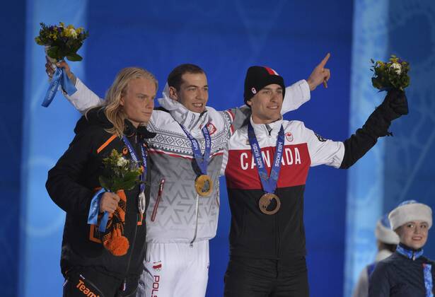 The Netherlands Koen Verweij, Poland s Zbigniew Brodka and Canada s Denny Morrison celebrate their silver, gold and bronze medals respectively during the victory ceremony for men s speed skating 1500M at the Sochi 2014 Winter Olympics on February 16, 2014 in Sochi, Russia.  OLY20140216740