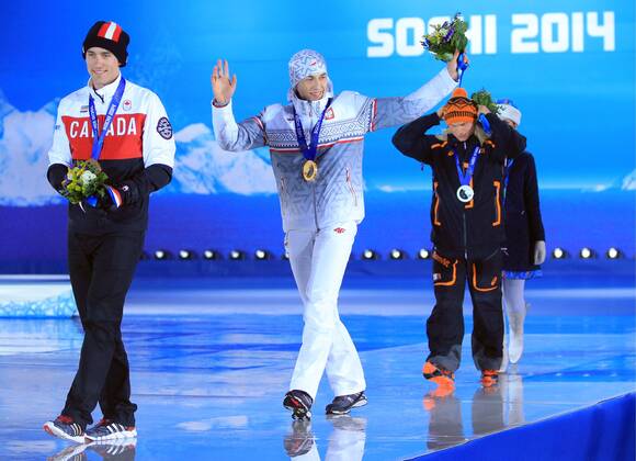 ITAR-TASS: SOCHI, RUSSIA. FEBRUARY 16, 2014. Canadian Denny Morrison (Bronze), Polish Zbigniew Brodka (Gold) and Dutch Koen Verweij (Silver), from left to right, at a victory ceremony for the men s 1500 metres speed skating event at the Sochi 2014 Winter Olympic Games, at Medals Plaza.  RE139BA3