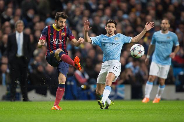 Cesc Fabregas of Barcelona and Jesus Navas of Manchester City in action - UEFA Champions League First Knockout Round - Manchester City vs Barcelona - Etihad Stadium - Manchester - England - 18th February 2014 - Picture Phil Oldham Sportimage EDITORIAL USE ONLY. No use with unauthorised audio, video, data, fixture lists, club league logos or live services. Online in-match use limited to 120 images, no video emulation. No use in betting, games or single club league player publications.