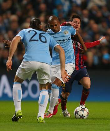Lionel Messi of Barcelona is unable to get past Fernandinho of Manchester City - UEFA Champions League First Knockout Round - Manchester City vs FC Barcelona - Etihad Stadium - Manchester - England - 18th February 2014 - Picture Dave Thompson Sportimage EDITORIAL USE ONLY. No use with unauthorised audio, video, data, fixture lists, club league logos or live services. Online in-match use limited to 120 images, no video emulation. No use in betting, games or single club league player publications.
