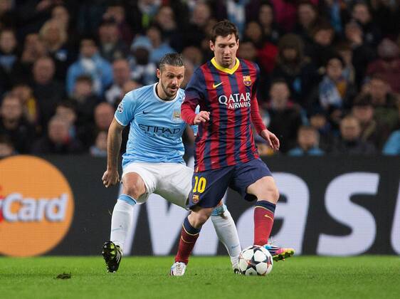Martin Demichelis of Manchester City keeps Lionel Messi of Barcelona at bay - UEFA Champions League First Knockout Round - Manchester City vs Barcelona - Etihad Stadium - Manchester - England - 18th February 2014 - Picture Phil Oldham Sportimage EDITORIAL USE ONLY. No use with unauthorised audio, video, data, fixture lists, club league logos or live services. Online in-match use limited to 120 images, no video emulation. No use in betting, games or single club league player publications.