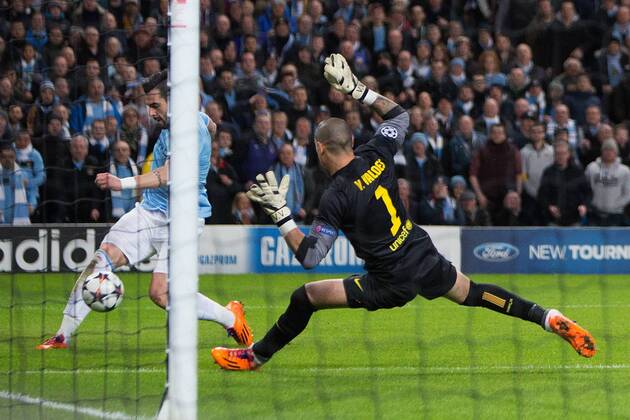 Alvaro Negredo of Manchester City chips the ball across the face of goal - UEFA Champions League First Knockout Round - Manchester City vs Barcelona - Etihad Stadium - Manchester - England - 18th February 2014 - Picture Phil Oldham Sportimage EDITORIAL USE ONLY. No use with unauthorised audio, video, data, fixture lists, club league logos or live services. Online in-match use limited to 120 images, no video emulation. No use in betting, games or single club league player publications.