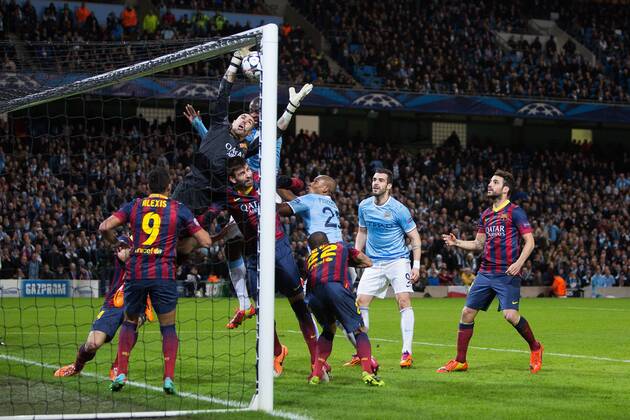 Victor Valdes of Barcelona struggles to reach a high ball during a goal mouth scramble - UEFA Champions League First Knockout Round - Manchester City vs Barcelona - Etihad Stadium - Manchester - England - 18th February 2014 - Picture Phil Oldham Sportimage EDITORIAL USE ONLY. No use with unauthorised audio, video, data, fixture lists, club league logos or live services. Online in-match use limited to 120 images, no video emulation. No use in betting, games or single club league player publications.