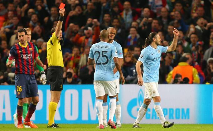 Martin Demichelis of Manchester City, right, is sent off after fouling Lionel Messi of Barcelona. - UEFA Champions League First Knockout Round - Manchester City vs FC Barcelona - Etihad Stadium - Manchester - England - 18th February 2014 - Picture Dave Thompson Sportimage EDITORIAL USE ONLY. No use with unauthorised audio, video, data, fixture lists, club league logos or live services. Online in-match use limited to 120 images, no video emulation. No use in betting, games or single club league player publications.