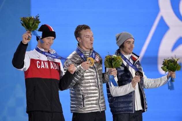 Canada s Mike Riddle, United States David Wise and France s Kevin Rolland pose for photos during the victory ceremony for men s freestyle ski half pipe at the Sochi 2014 Winter Olympics on February 19, 2014 in Sochi, Russia. Riddle won silver, Wise gold and Rolland bronze in the event.  OLY20140219146