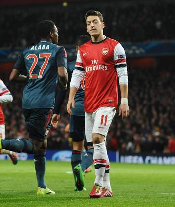Football - 2013 2014 Champions League - Round of 16, First Leg: Arsenal vs. Bayern Munich Arsenal s Mesut Ozil shows his dejection after missing his Penalty kick at The Emirates. COLORSPORT ANDREW COWIE 