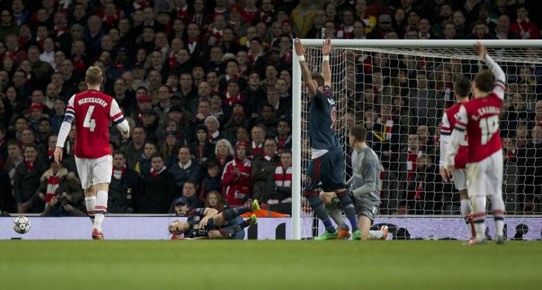 19.02.2014 London, England. Arjen Robben of Bayern Munich is left grounded from a challenge by Wojciech Szczesny of Arsenal during the Champions League game between Arsenal and Bayern Munich from the Emirates Stadium. Wojciech Szczesny was shown a red card as Munich went on to win 2-0. xNigelxCookex  ActionPlus20176012