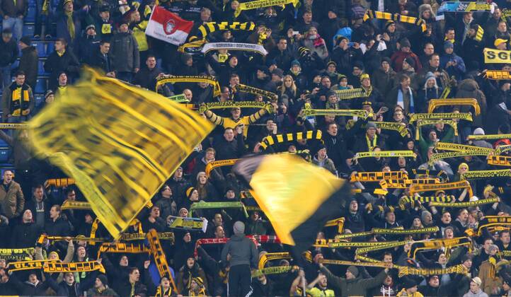 ITAR-TASS: ST PETERSBURG, RUSSIA. FEBRUARY 25, 2014. Borussia Dortmund fans wave flags as they watch action in a UEFA Champions League Round of Last 16 football match at Petrovsky Stadium.  premiumd RE13B036