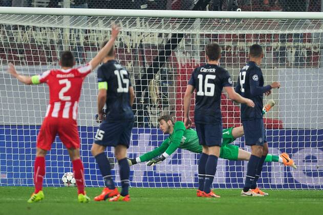 David de Gea of Manchester United can t quite reach far enough to stop the opening goal - UEFA Champions League First Knockout Round - Olympiacos vs. Manchester United - Karaiskakh Stadium - Athens - Greece - 25th February 2014 - EDITORIAL USE ONLY. No use with unauthorised audio, video, data, fixture lists, club league logos or live services. Online in-match use limited to 120 images, no video emulation. No use in betting, games or single club league player publications.