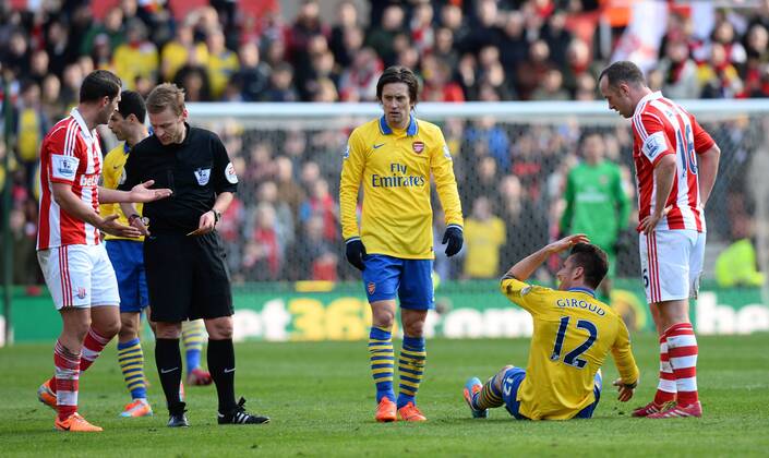 Erik Pieters of Stoke City receives a yellow card for fouling Olivier Giroud of Arsenal - Barclays Premier League - Stoke City vs Arsenal FC London FC London - Britannia Stadium - Stoke - England - 29th February 2014 EDITORIAL USE ONLY. No use with unauthorised audio, video, data, fixture lists, club league logos or live services. Online in-match use limited to 120 images, no video emulation. No use in betting, games or single club league player publications.