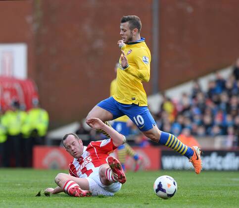 Jack Wilshere of Arsenal tackled by Charlie Adams of Stoke City - Barclays Premier League - Stoke City vs Arsenal FC London FC London - Britannia Stadium - Stoke - England - 29th February 2014 EDITORIAL USE ONLY. No use with unauthorised audio, video, data, fixture lists, club league logos or live services. Online in-match use limited to 120 images, no video emulation. No use in betting, games or single club league player publications.