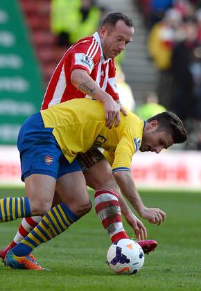 Charlie Adams of Stoke City tackles Olivier Giroud of Arsenal - Barclays Premier League - Stoke City vs Arsenal FC London FC London - Britannia Stadium - Stoke - England - 29th February 2014 EDITORIAL USE ONLY. No use with unauthorised audio, video, data, fixture lists, club league logos or live services. Online in-match use limited to 120 images, no video emulation. No use in betting, games or single club league player publications.