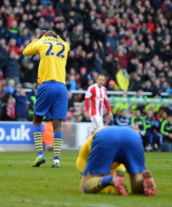 Yaya Sanogo of Arsenal hides his face after missing a last minute chance to score - Barclays Premier League - Stoke City vs Arsenal FC London - Britannia Stadium - Stoke - England - 29th February 2014 - EDITORIAL USE ONLY. No use with unauthorised audio, video, data, fixture lists, club league logos or live services. Online in-match use limited to 120 images, no video emulation. No use in betting, games or single club league player publications.
