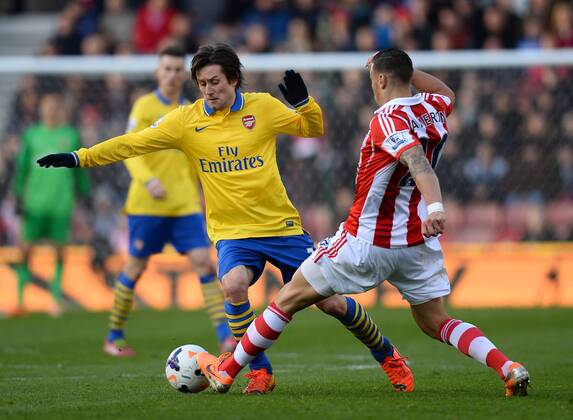 Tomas Rosicky of Arsenal tackled by Geoff Cameron of Stoke City - Barclays Premier League - Stoke City vs Arsenal FC London - Britannia Stadium - Stoke - England - 29th February 2014 - EDITORIAL USE ONLY. No use with unauthorised audio, video, data, fixture lists, club league logos or live services. Online in-match use limited to 120 images, no video emulation. No use in betting, games or single club league player publications.