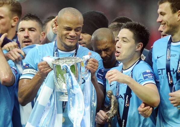Football - 2014 Capital One League Cup Final - Manchester City vs. AFC Sunderland FC - City s Vincent Kompany and Samir Nasri celebrate with the trophy at Wembley. 