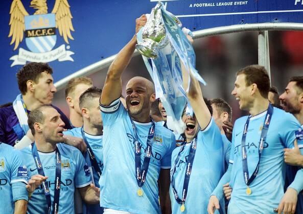 Football - 2014 Capital One League Cup Final - Manchester City vs. AFC Sunderland FC - City s Vincent Kompany celebrates with the trophy at Wembley. 