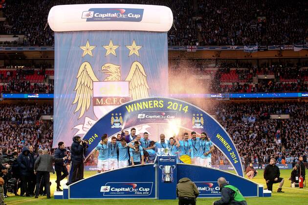 Manchester City s Vincent Kompany lifts the trophy with his team - Manchester City - League Cup Final - Wembley Stadium - London - 2nd March 2014 - EDITORIAL USE ONLY. No use with unauthorised audio, video, data, fixture lists, club league logos or live services. Online in-match use limited to 120 images, no video emulation. No use in betting, games or single club league player publications.