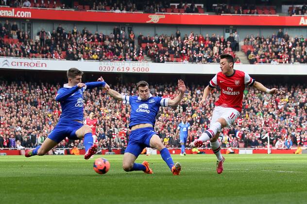 Arsenal s Mesut Ozil scoring his sides opening goal Arsenal v Everton - FA Cup Quarter Final - Emirates Stadium - London - England - 08 03 2014 - Pic David Klein Sportimage EDITORIAL USE ONLY. No use with unauthorised audio, video, data, fixture lists, club league logos or live services. Online in-match use limited to 120 images, no video emulation. No use in betting, games or single club league player publications.