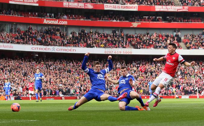 Arsenal s Mesut Ozil scoring his sides opening goal Arsenal v Everton - FA Cup Quarter Final - Emirates Stadium - London - England - 08 03 2014 - Pic David Klein Sportimage EDITORIAL USE ONLY. No use with unauthorised audio, video, data, fixture lists, club league logos or live services. Online in-match use limited to 120 images, no video emulation. No use in betting, games or single club league player publications.